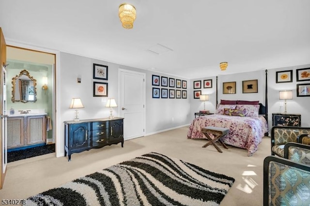 carpeted bedroom featuring connected bathroom and baseboards