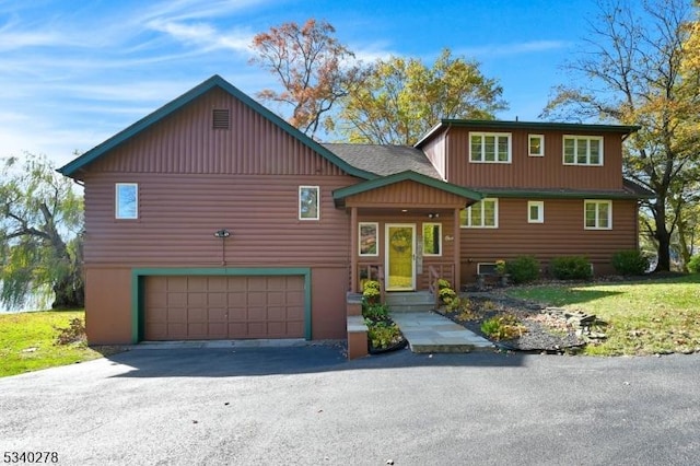 view of front of property with an attached garage and aphalt driveway