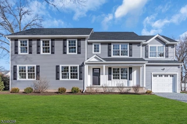 colonial home with a front lawn, roof with shingles, and an attached garage