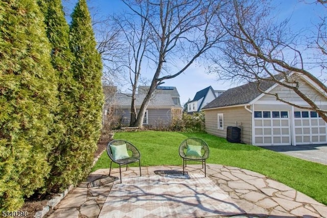 view of patio / terrace featuring a garage and central AC unit