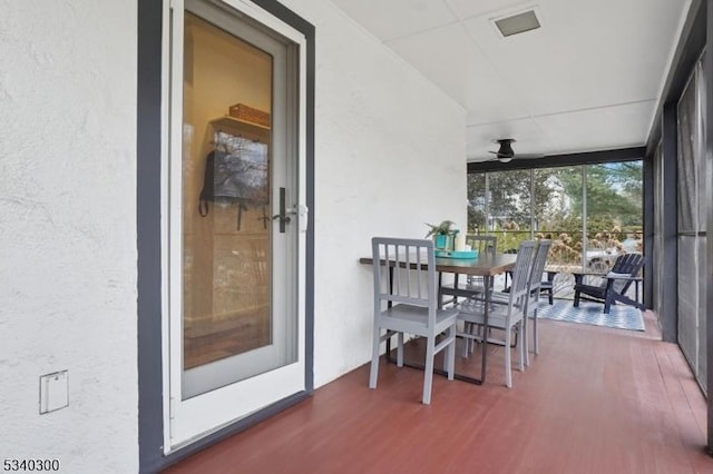 sunroom featuring ceiling fan