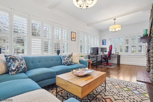 living area featuring ornamental molding, wood finished floors, beam ceiling, and an inviting chandelier