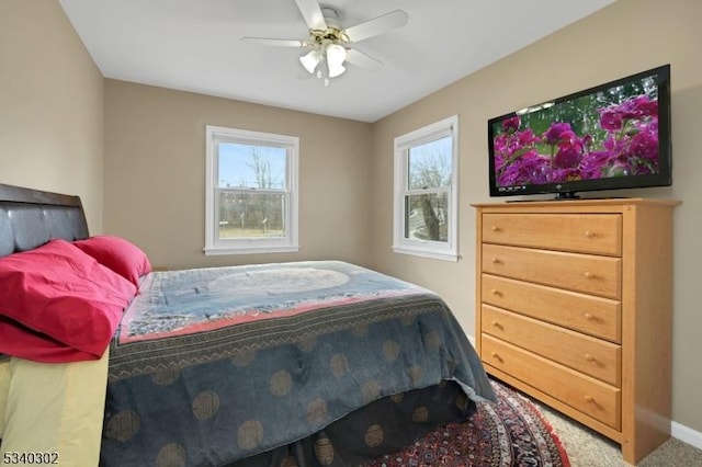 bedroom featuring baseboards, a ceiling fan, and carpet flooring