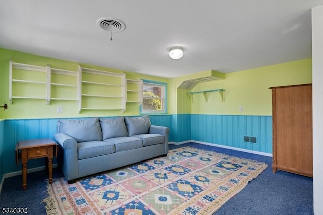 living room featuring visible vents, wainscoting, and carpet flooring