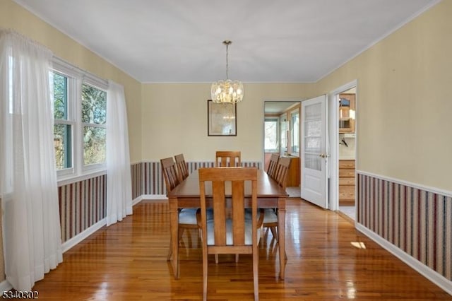 dining space featuring an inviting chandelier and wood finished floors