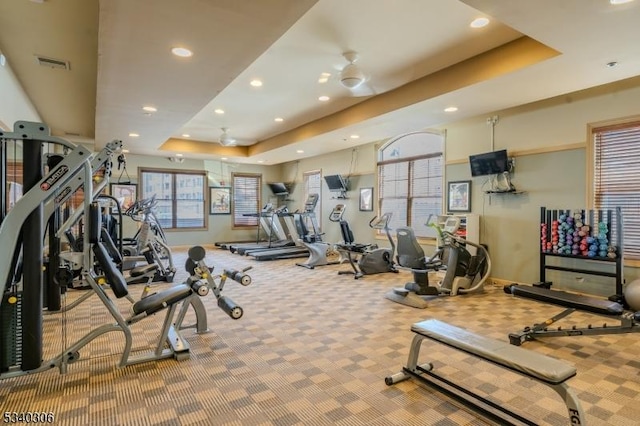 gym featuring carpet floors, visible vents, a raised ceiling, and recessed lighting