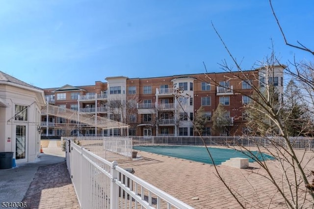 pool featuring a patio area and fence