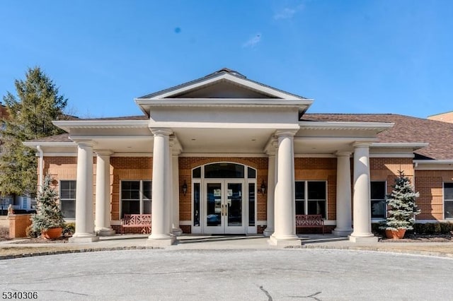 entrance to property with brick siding and french doors