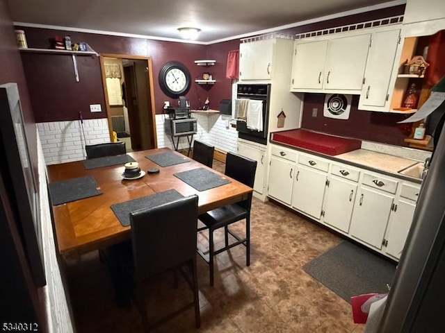 4 Deer Path, Clinton Twp, NJ 08833 - kitchen featuring black oven, open shelves, dark floors, crown molding, and stainless steel microwave