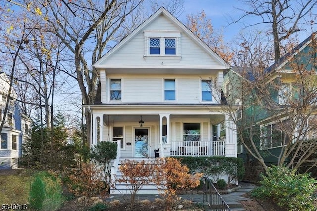 american foursquare style home with covered porch