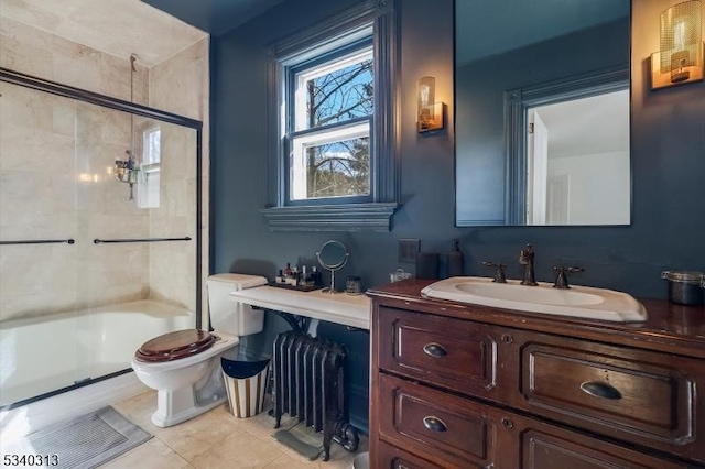 full bathroom featuring vanity, tile patterned floors, toilet, and a shower with shower door