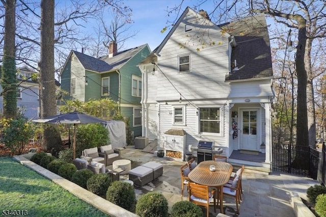 rear view of property featuring central air condition unit, an outdoor living space, and a patio