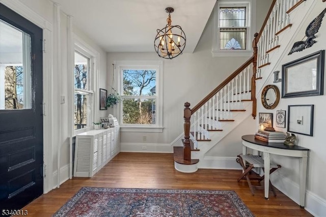 entrance foyer featuring a wealth of natural light, wood finished floors, and stairs