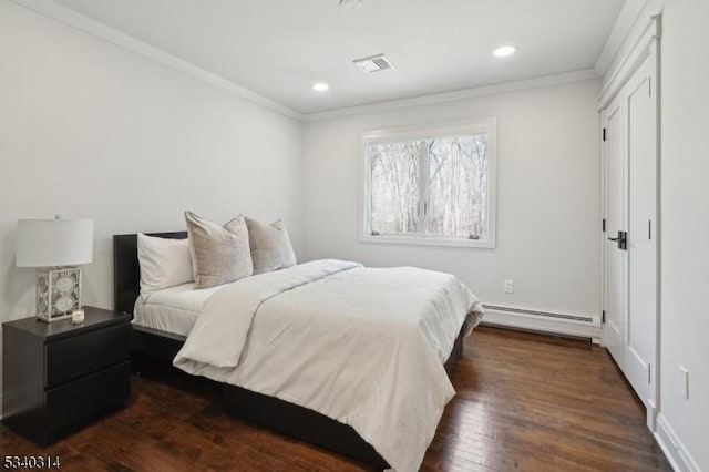 bedroom featuring visible vents, ornamental molding, baseboard heating, and dark wood-type flooring