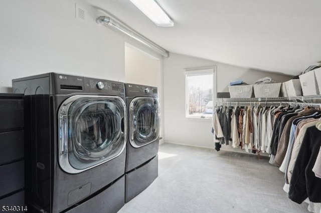 washroom featuring light carpet, laundry area, visible vents, and washing machine and clothes dryer