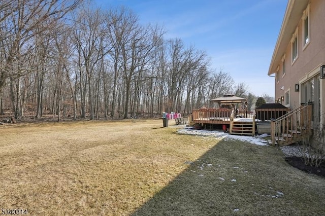 view of yard featuring a deck and a gazebo