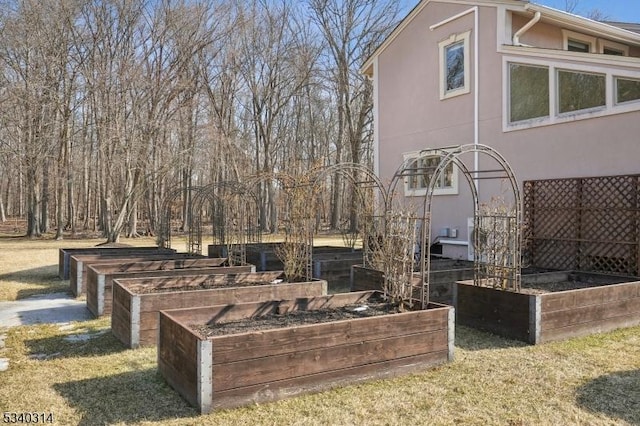 view of home's exterior featuring a garden, a lawn, and stucco siding