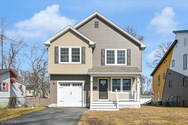 view of front facade with covered porch, driveway, a front yard, and a garage