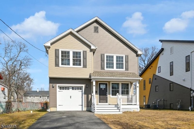 view of front of property with driveway, a garage, fence, cooling unit, and a porch