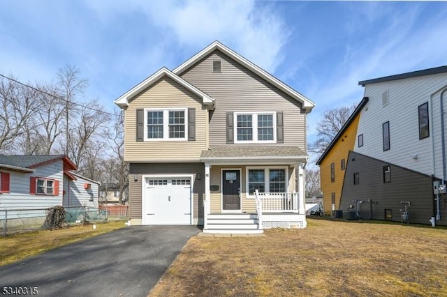 view of front of property featuring driveway, an attached garage, a porch, and a front yard