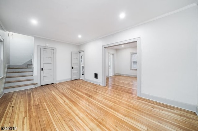 unfurnished room with baseboards, stairway, crown molding, light wood-type flooring, and recessed lighting