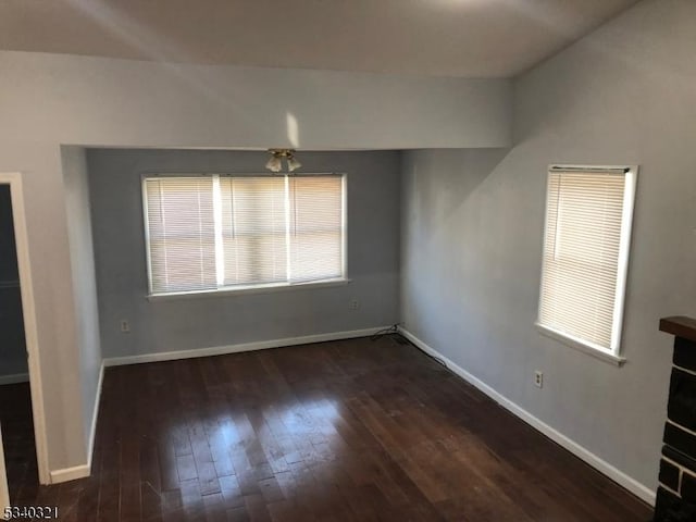 interior space with wood-type flooring and baseboards