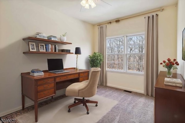 home office featuring a ceiling fan, carpet, visible vents, and baseboards