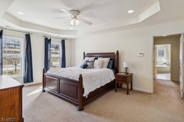 bedroom featuring baseboards, a tray ceiling, recessed lighting, and light colored carpet