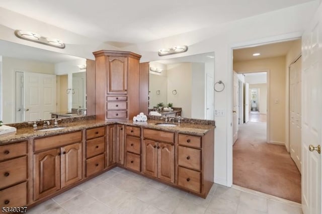 full bathroom featuring double vanity, a sink, and tile patterned floors