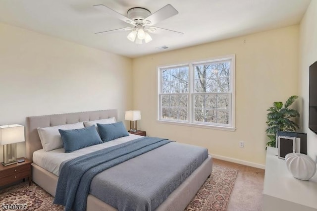 carpeted bedroom featuring visible vents, ceiling fan, and baseboards