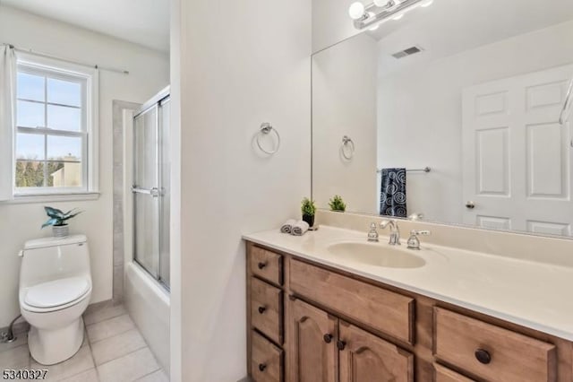 bathroom with visible vents, toilet, enclosed tub / shower combo, tile patterned floors, and vanity