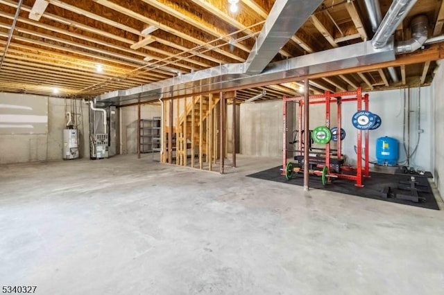 unfinished basement featuring heating unit and gas water heater