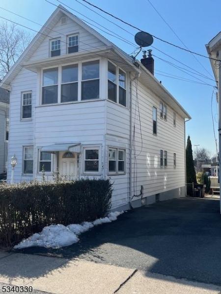 view of side of home featuring a chimney