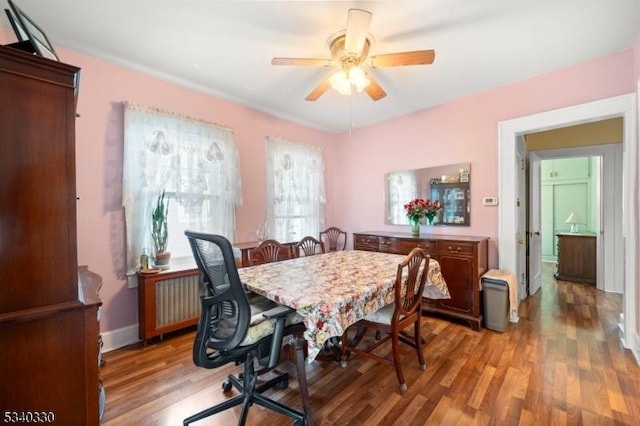 dining space with a ceiling fan and light wood finished floors