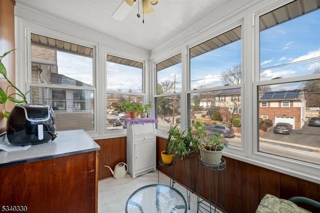 sunroom featuring ceiling fan