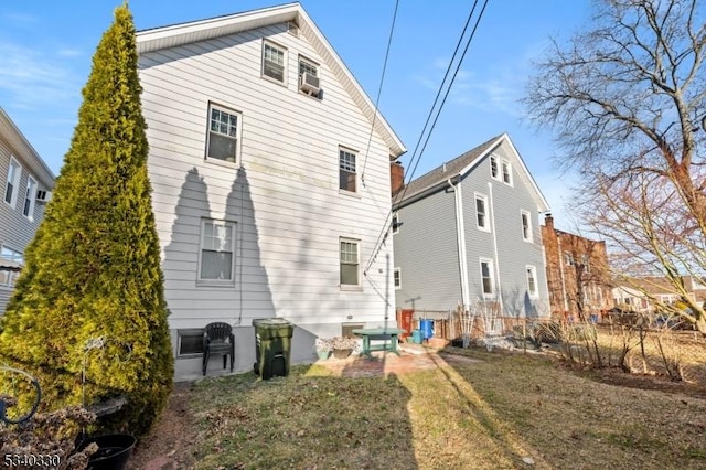 rear view of house featuring a yard