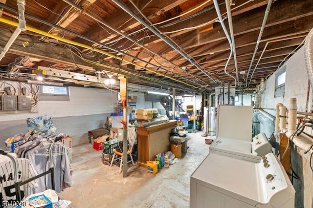 below grade area featuring gas water heater, washing machine and clothes dryer, and electric panel