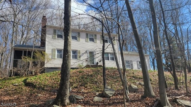 view of property exterior with a chimney