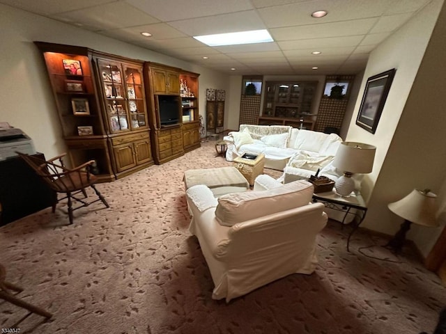 living room featuring recessed lighting, a drop ceiling, and light colored carpet