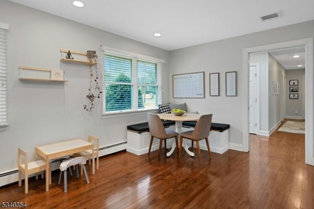 dining room featuring breakfast area, recessed lighting, and wood finished floors