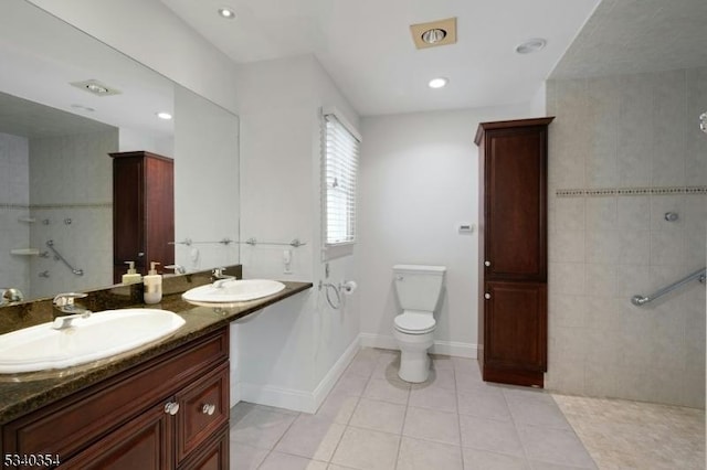 full bath with walk in shower, tile patterned flooring, a sink, and baseboards