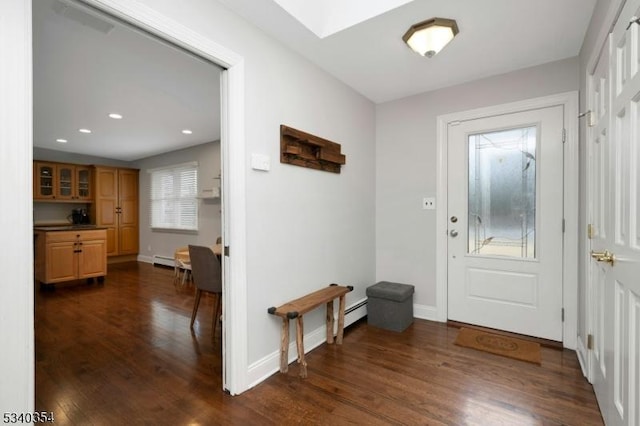 entrance foyer featuring a skylight, dark wood finished floors, recessed lighting, baseboard heating, and baseboards