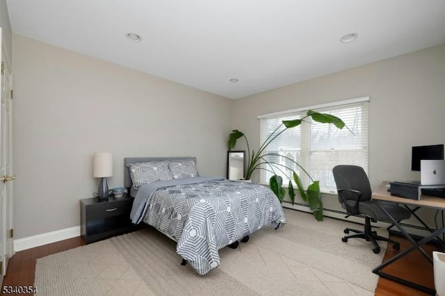 bedroom with wood finished floors and baseboards