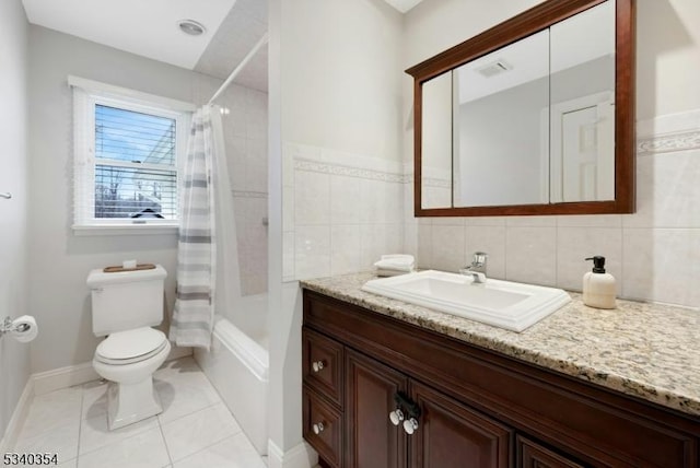 full bath featuring toilet, tile patterned flooring, shower / bath combination with curtain, vanity, and tile walls