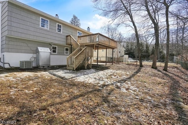 rear view of house featuring a chimney, stairway, fence, a wooden deck, and central AC