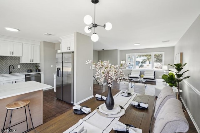 interior space featuring dark wood-style floors, visible vents, and baseboards