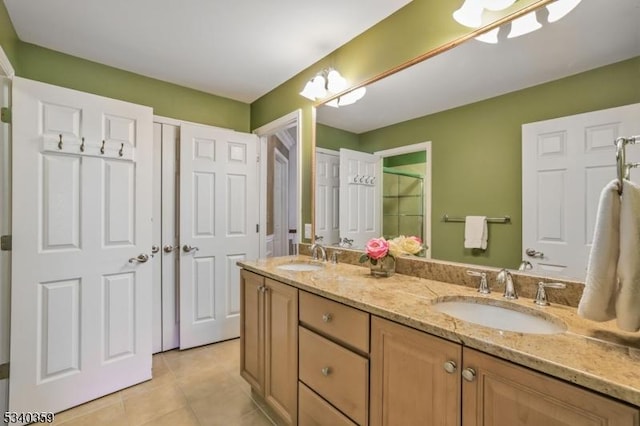 full bath with tile patterned flooring, double vanity, and a sink