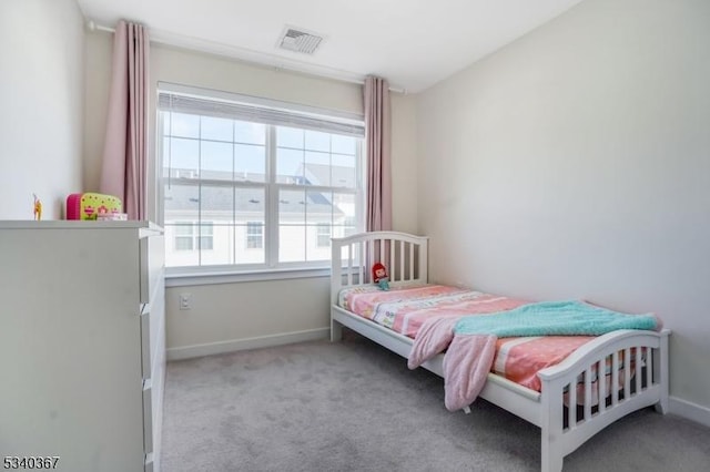 bedroom with light colored carpet, visible vents, and baseboards