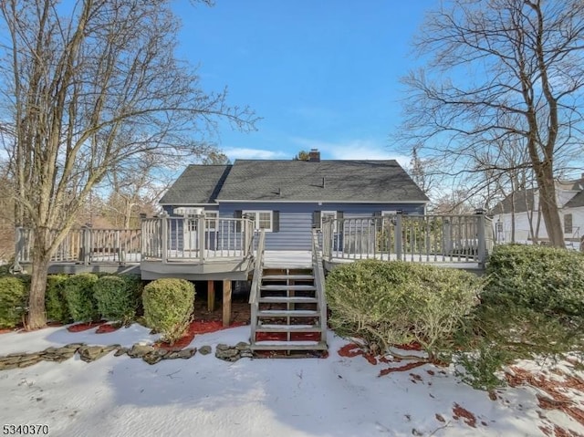 back of house featuring a deck, a chimney, and stairway