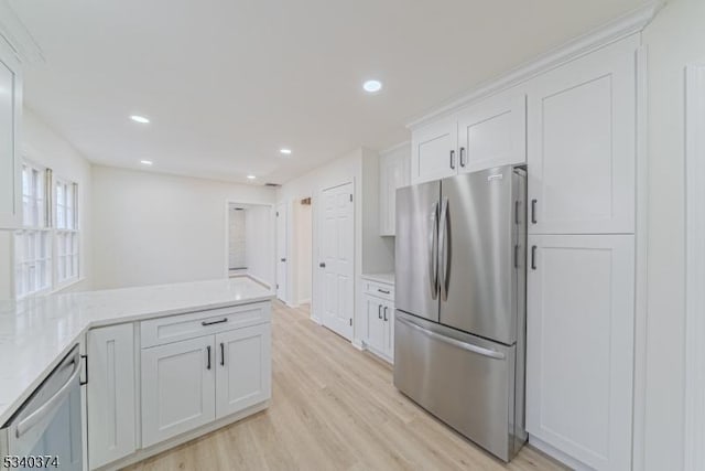 kitchen featuring appliances with stainless steel finishes, light wood-type flooring, white cabinets, and recessed lighting